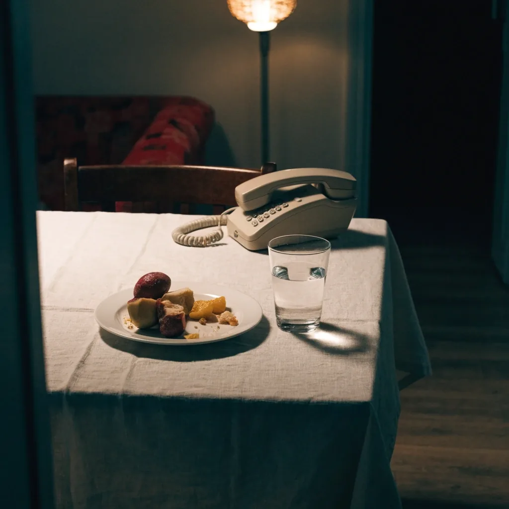 A warm-lit doorway from a kitchen into a hallway at night