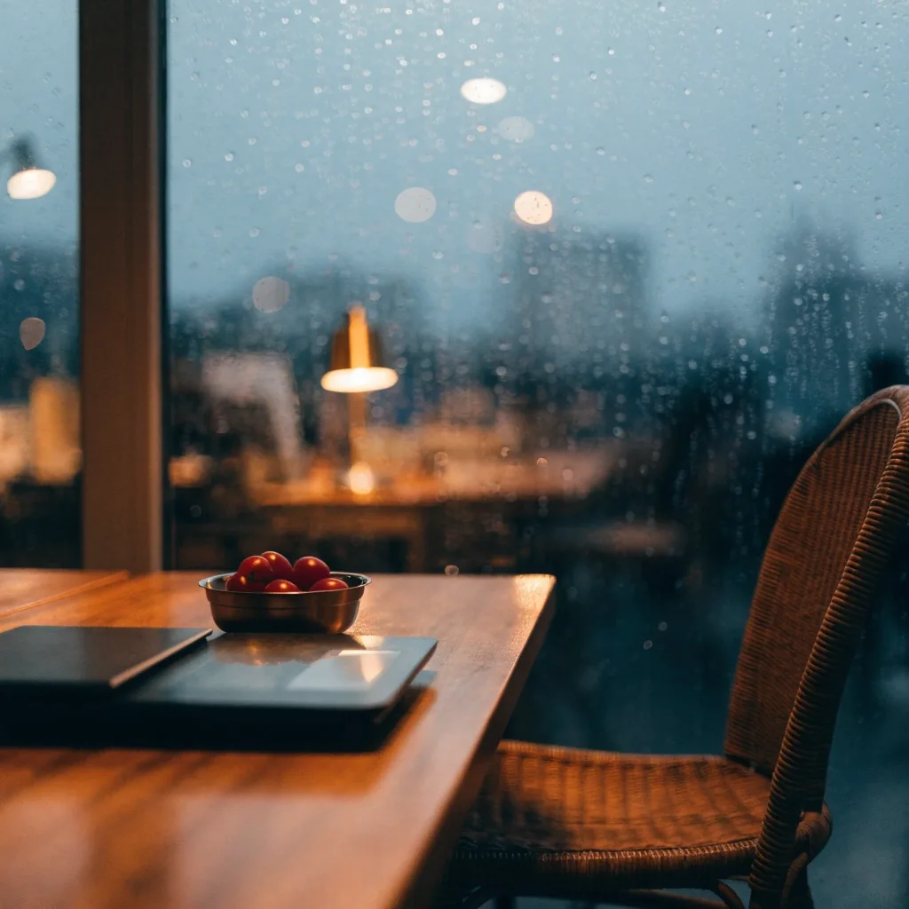 Blank intake papers and a pen on a kitchen table under one warm lamp